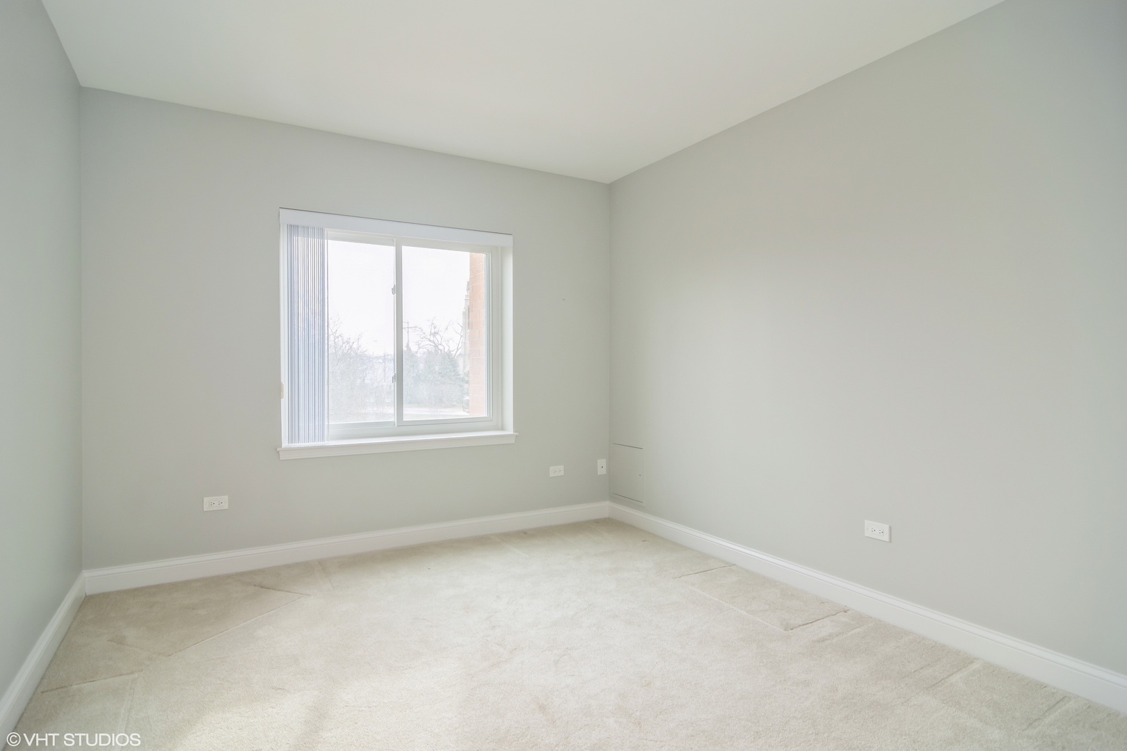 125 North Buffalo Grove Road, Unit 110 Buffalo Grove, IL 60089 - Photo 11 of 14 an empty room with a window