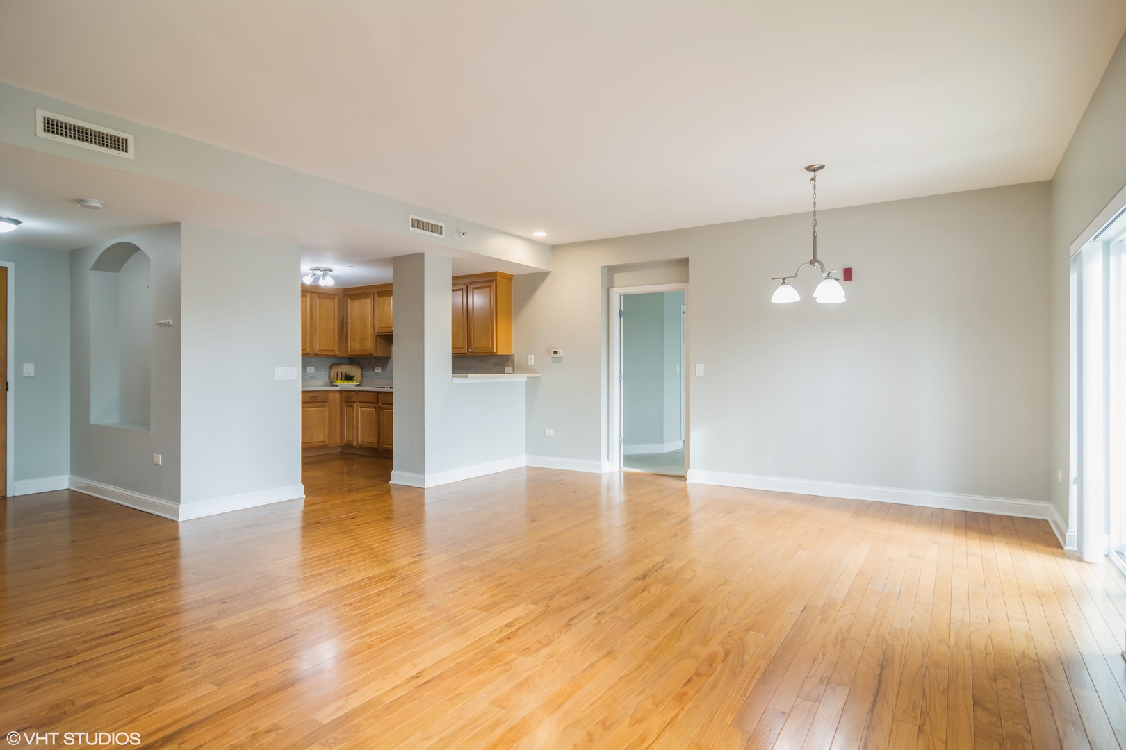 125 North Buffalo Grove Road, Unit 110 Buffalo Grove, IL 60089 - Photo 4 of 14 a view of empty room with wooden floor