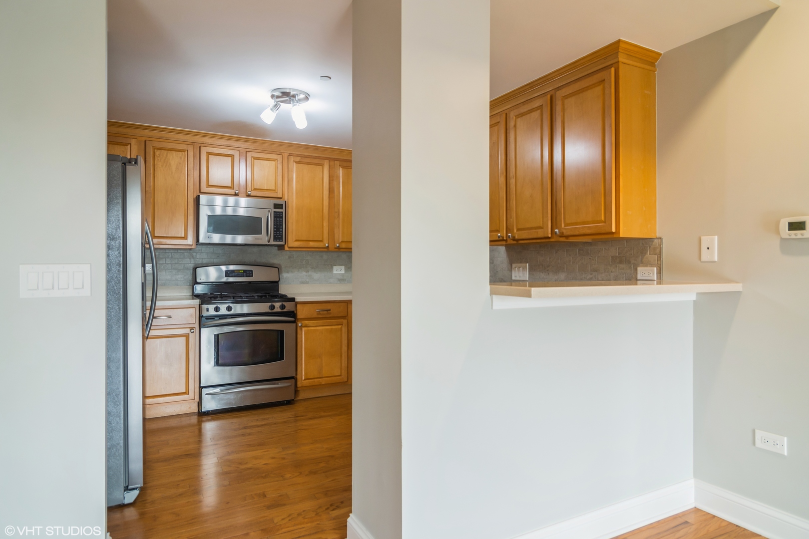 125 North Buffalo Grove Road, Unit 110 Buffalo Grove, IL 60089 - Photo 5 of 14 a kitchen with stainless steel appliances a stove and a refrigerator