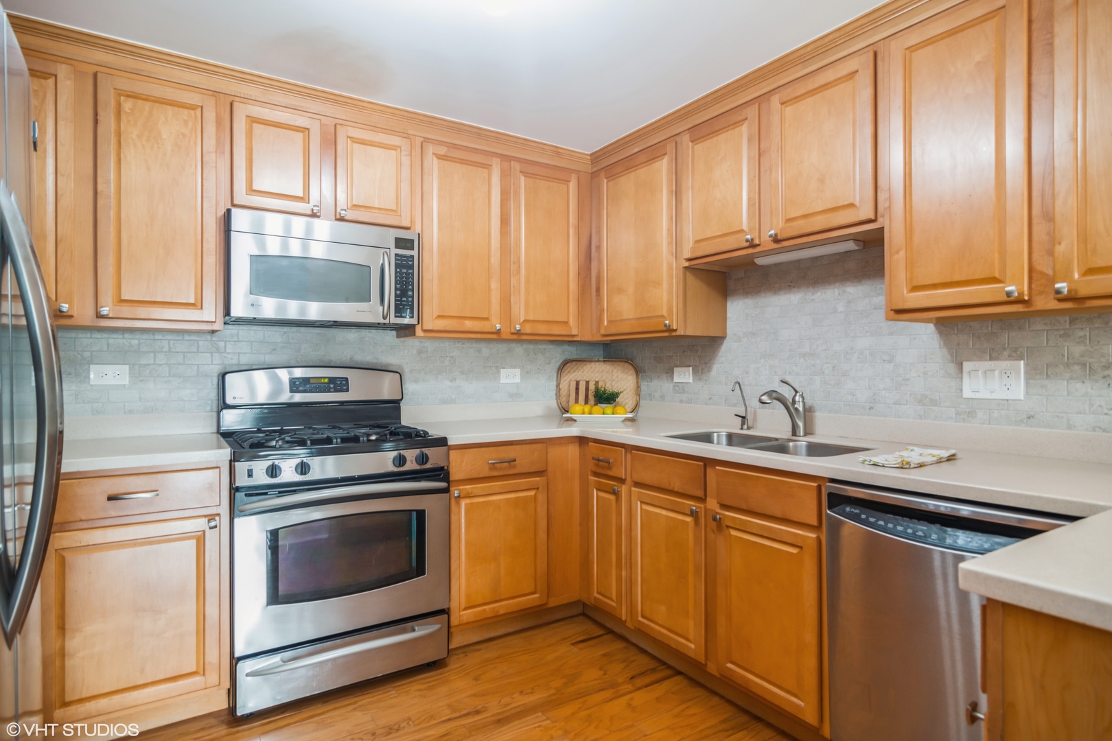 125 North Buffalo Grove Road, Unit 110 Buffalo Grove, IL 60089 - Photo 6 of 14 a kitchen with a sink stove top oven and cabinets