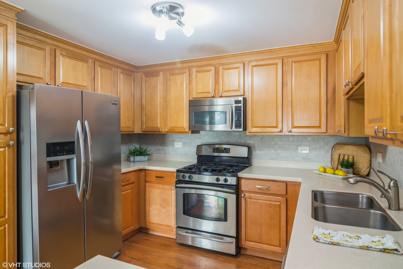 125 North Buffalo Grove Road, Unit 110 Buffalo Grove, IL 60089 - Photo 7 of 14 a kitchen with stainless steel appliances granite countertop a refrigerator sink and stove