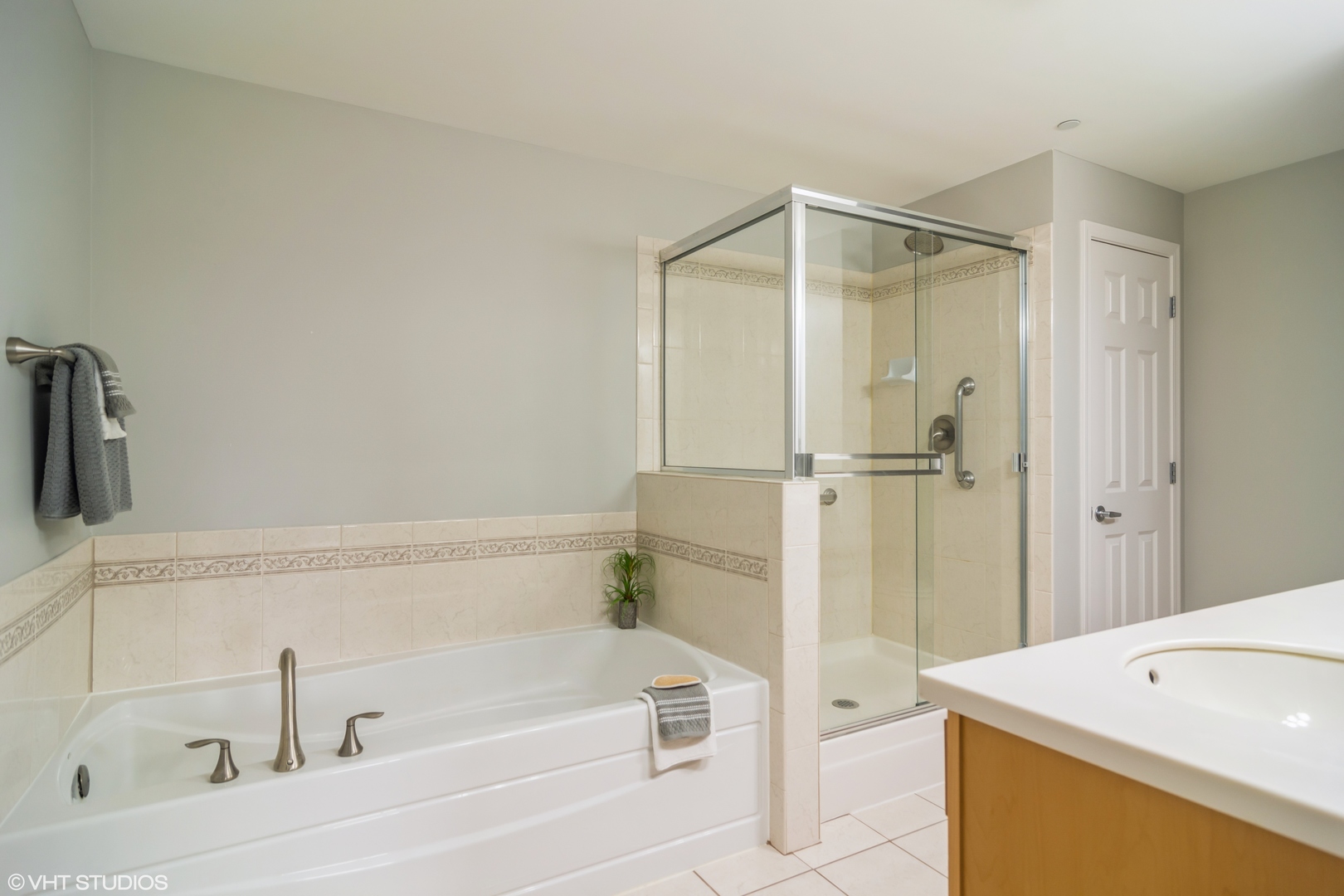 125 North Buffalo Grove Road, Unit 110 Buffalo Grove, IL 60089 - Photo 9 of 14 a bathroom with a bathtub and a shower
