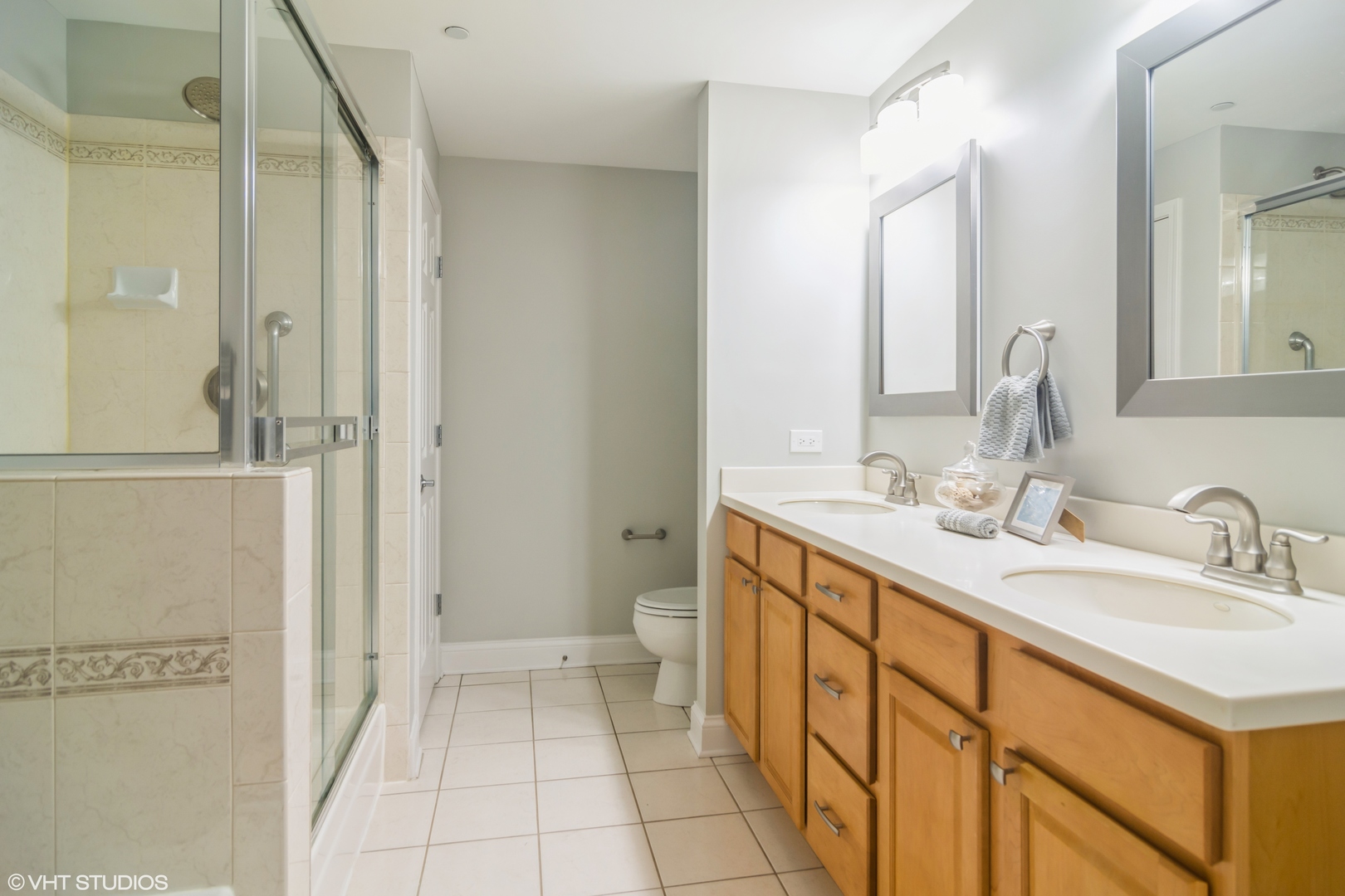 125 North Buffalo Grove Road, Unit 110 Buffalo Grove, IL 60089 - Photo 10 of 14 a spacious bathroom with a double vanity sink toilet and shower