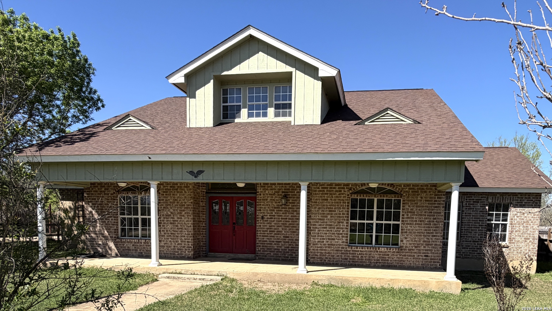 a front view of a house with a yard