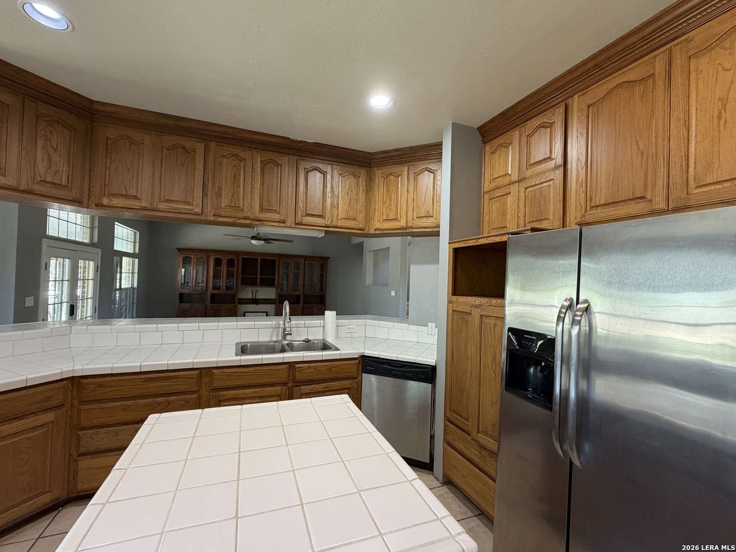 10565 Briggs Road Atascosa, TX 78002 - Photo 11 of 59 a kitchen with kitchen island granite countertop a refrigerator stove top oven and sink