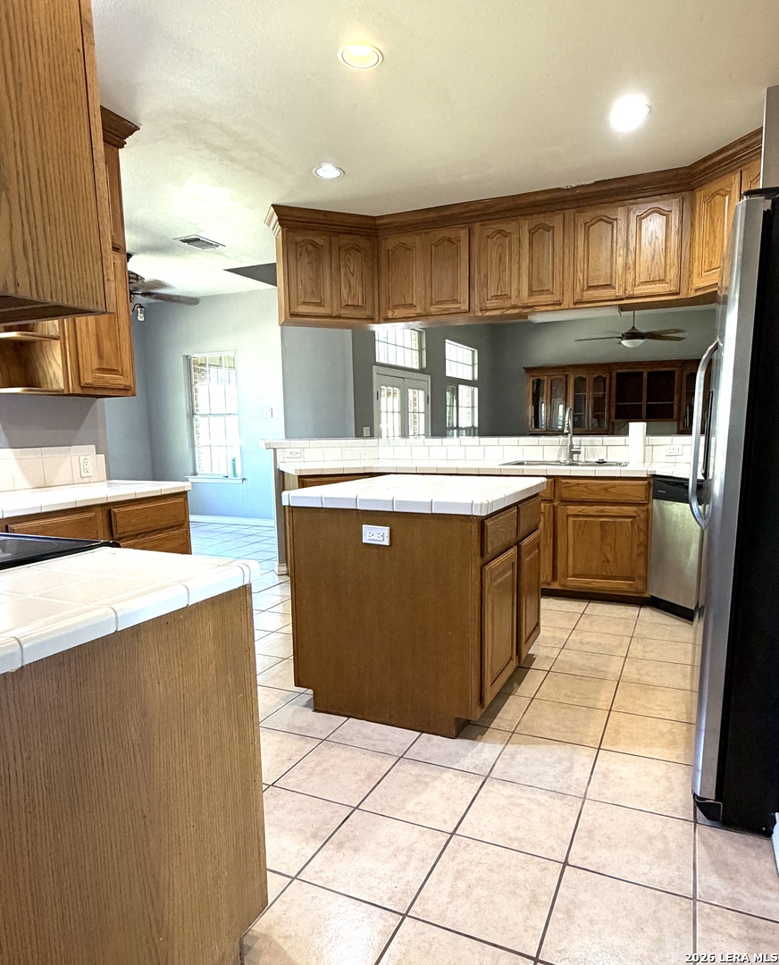 10565 Briggs Road Atascosa, TX 78002 - Photo 12 of 59 a kitchen with stainless steel appliances a sink and cabinets