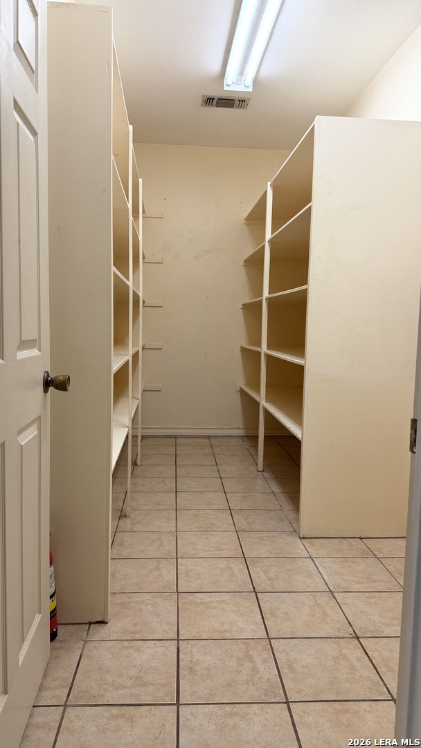 10565 Briggs Road Atascosa, TX 78002 - Photo 13 of 59 a view of walk in closet with empty racks