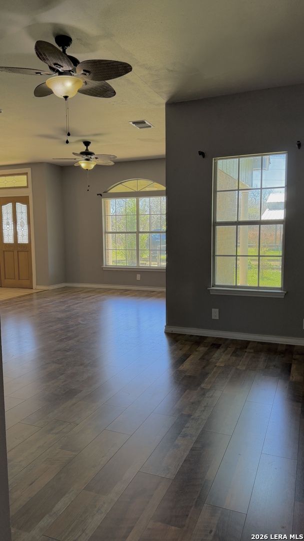 10565 Briggs Road Atascosa, TX 78002 - Photo 14 of 59 an empty room with wooden floor and windows