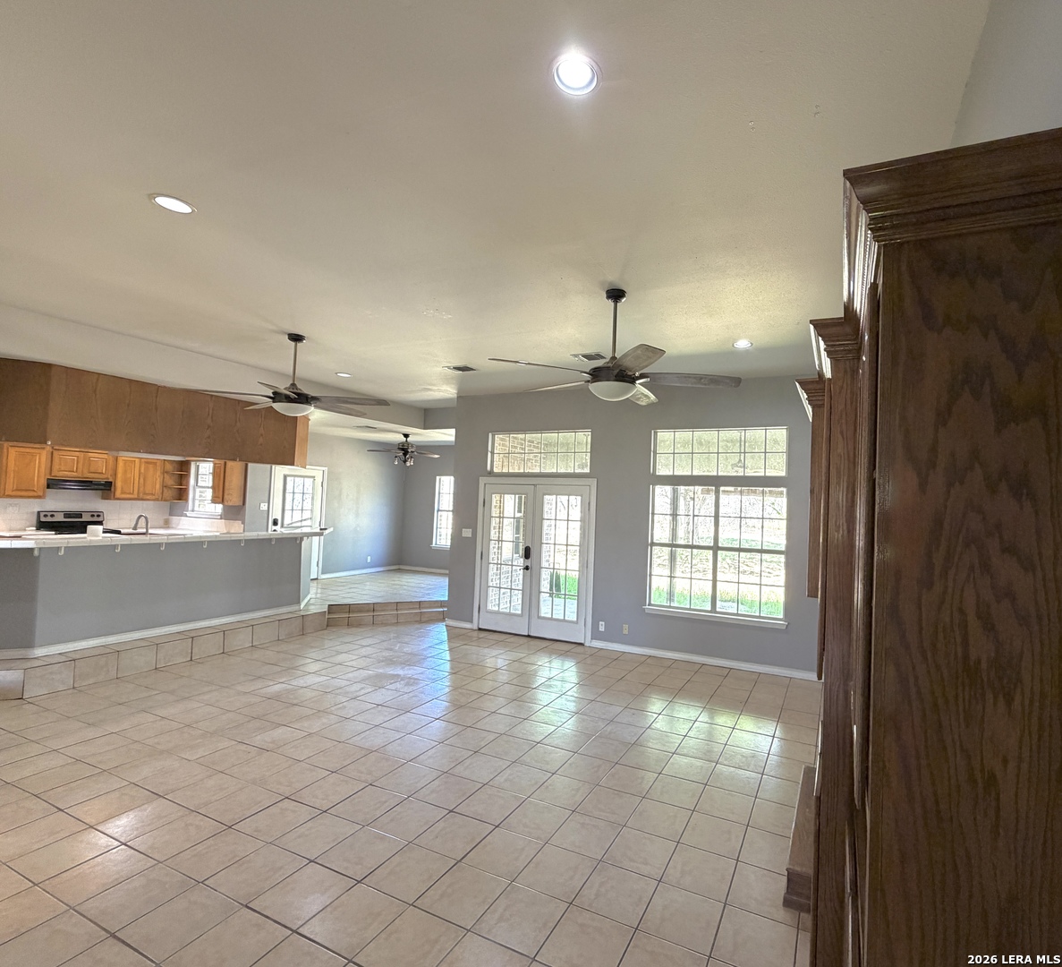 10565 Briggs Road Atascosa, TX 78002 - Photo 19 of 59 an empty room with wooden floor and windows