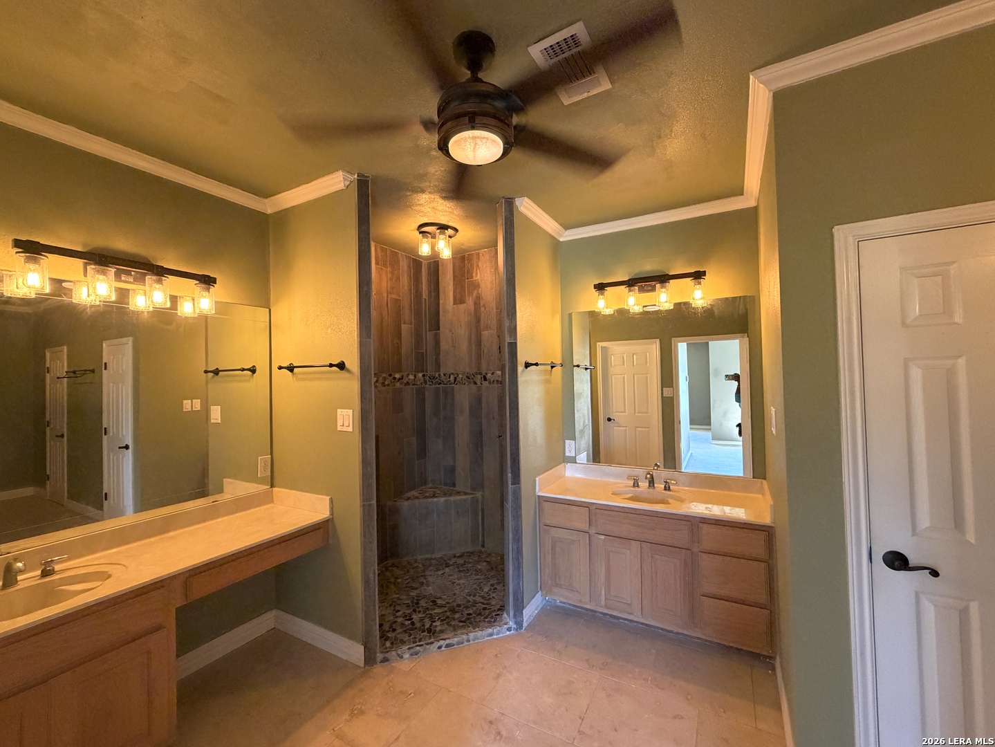 10565 Briggs Road Atascosa, TX 78002 - Photo 22 of 59 a bathroom with a double vanity sink mirror and shower