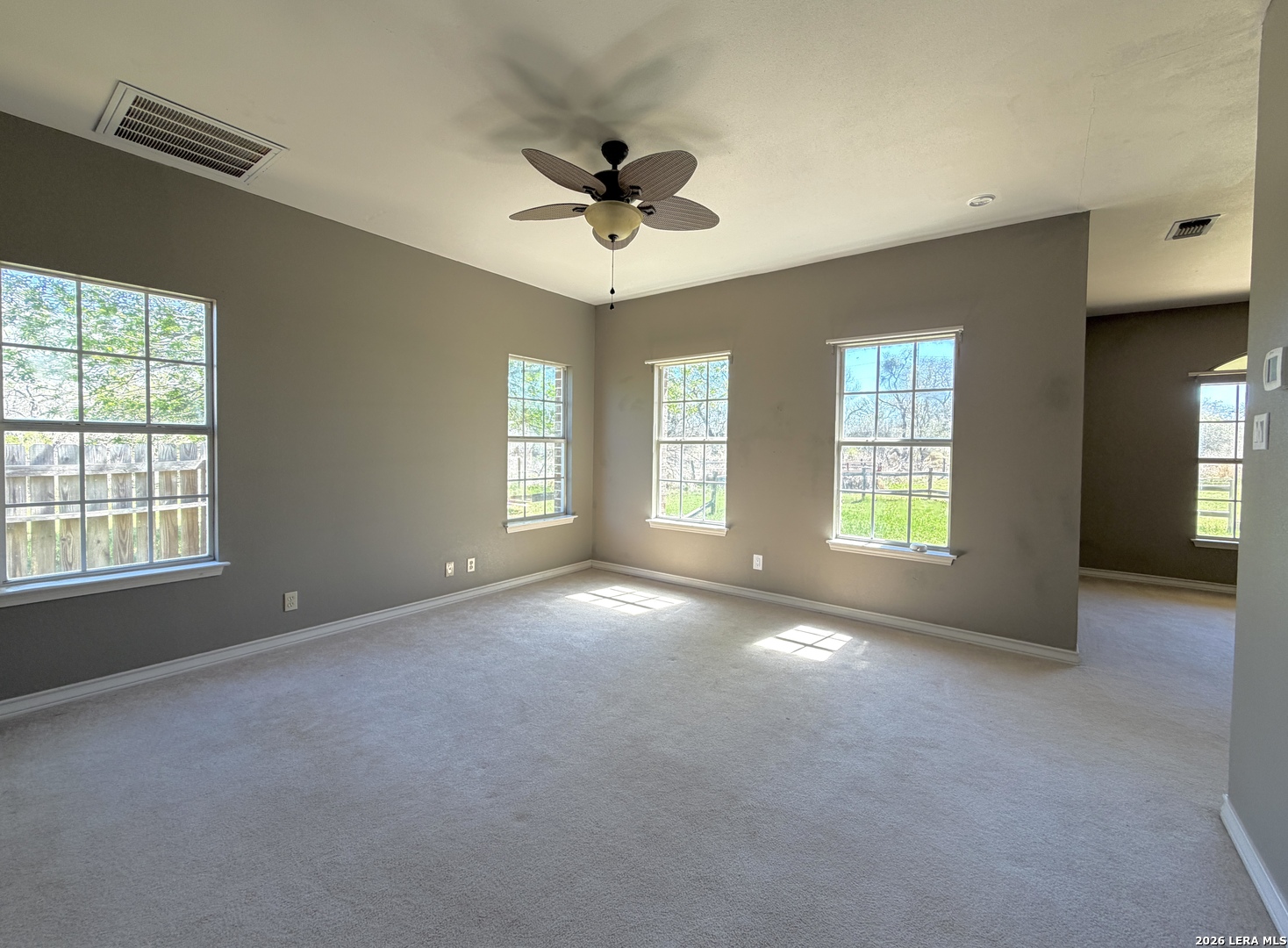 10565 Briggs Road Atascosa, TX 78002 - Photo 35 of 59 a view of an empty room with a window and a kitchen