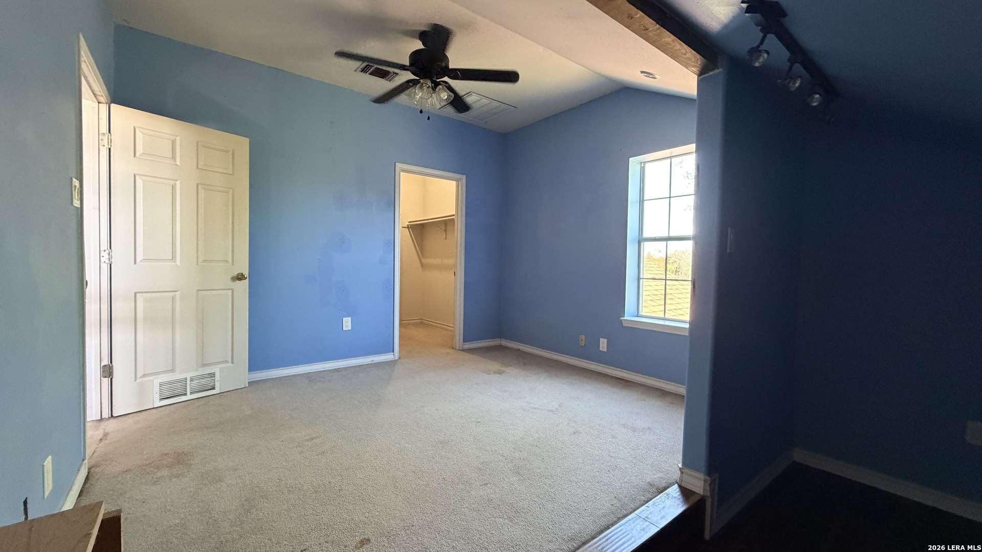 10565 Briggs Road Atascosa, TX 78002 - Photo 49 of 59 an empty room with windows and fan