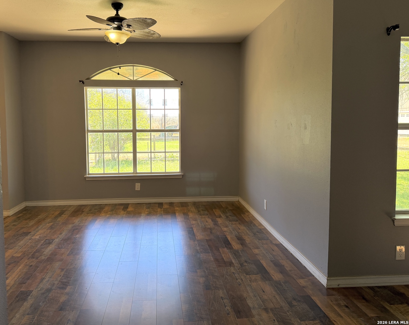 10565 Briggs Road Atascosa, TX 78002 - Photo 5 of 59 a view of an empty room with wooden floor and a window