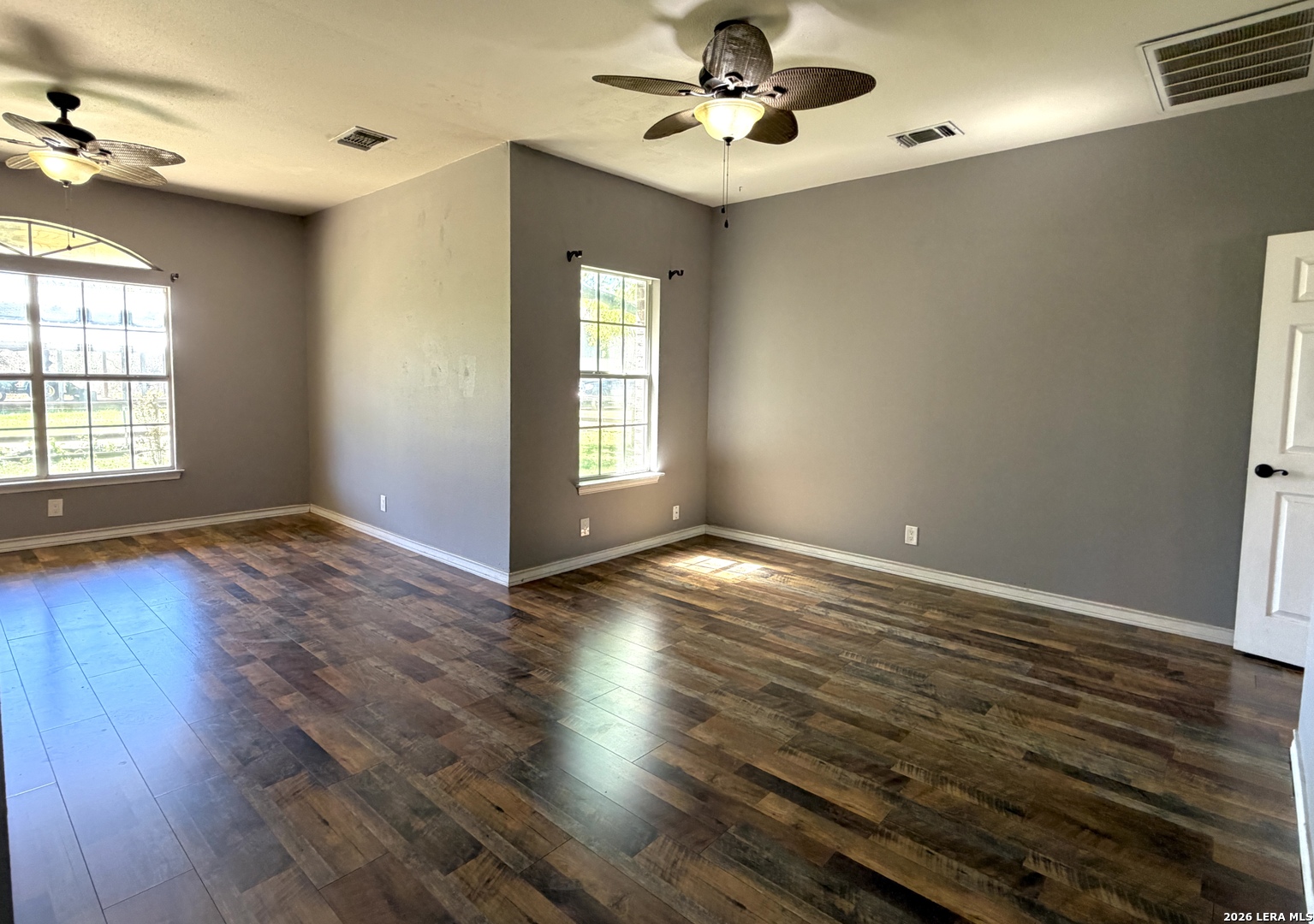 10565 Briggs Road Atascosa, TX 78002 - Photo 6 of 59 a view of an empty room with wooden floor and a window
