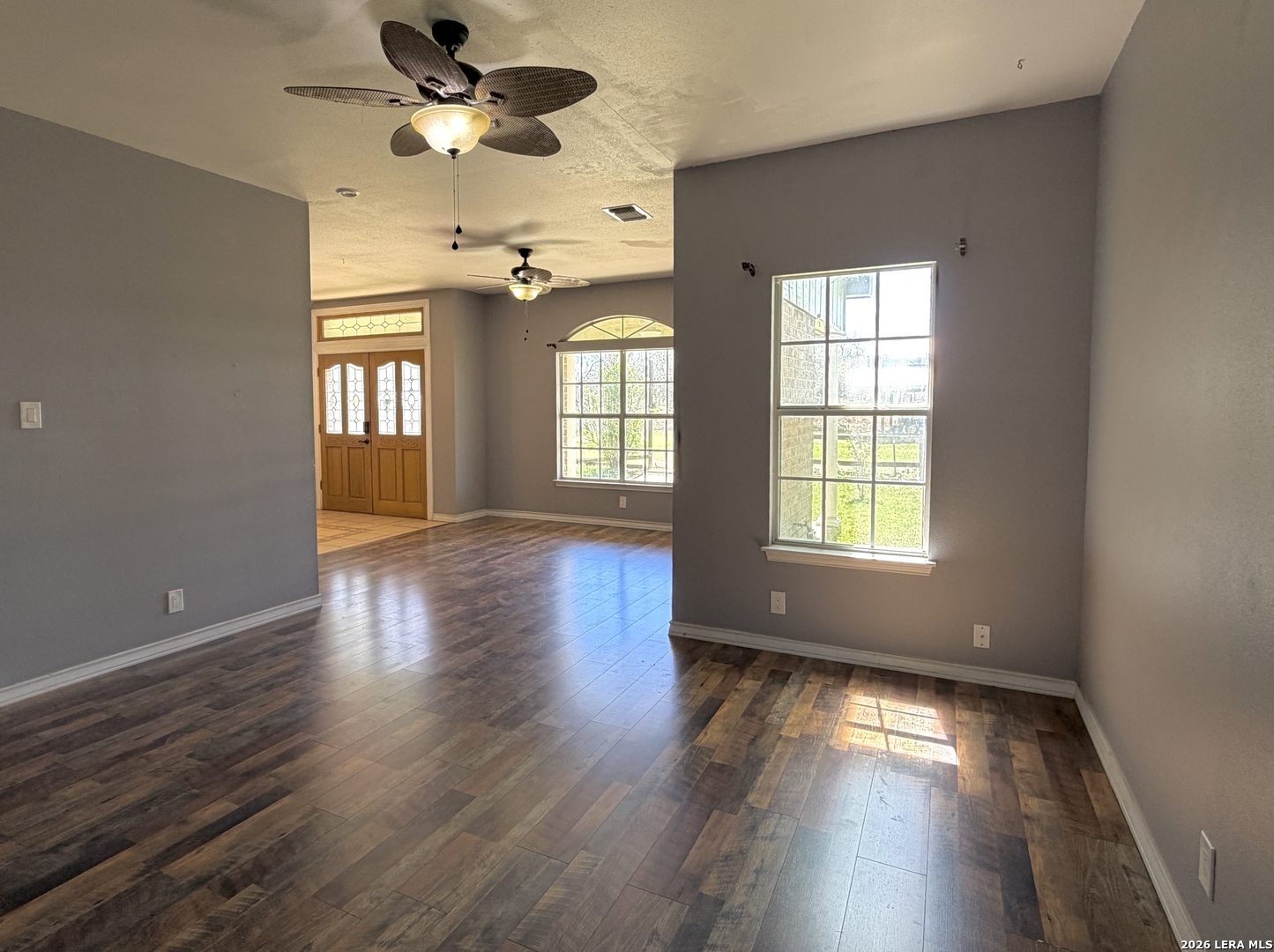 10565 Briggs Road Atascosa, TX 78002 - Photo 7 of 59 a view of an empty room with wooden floor and a window