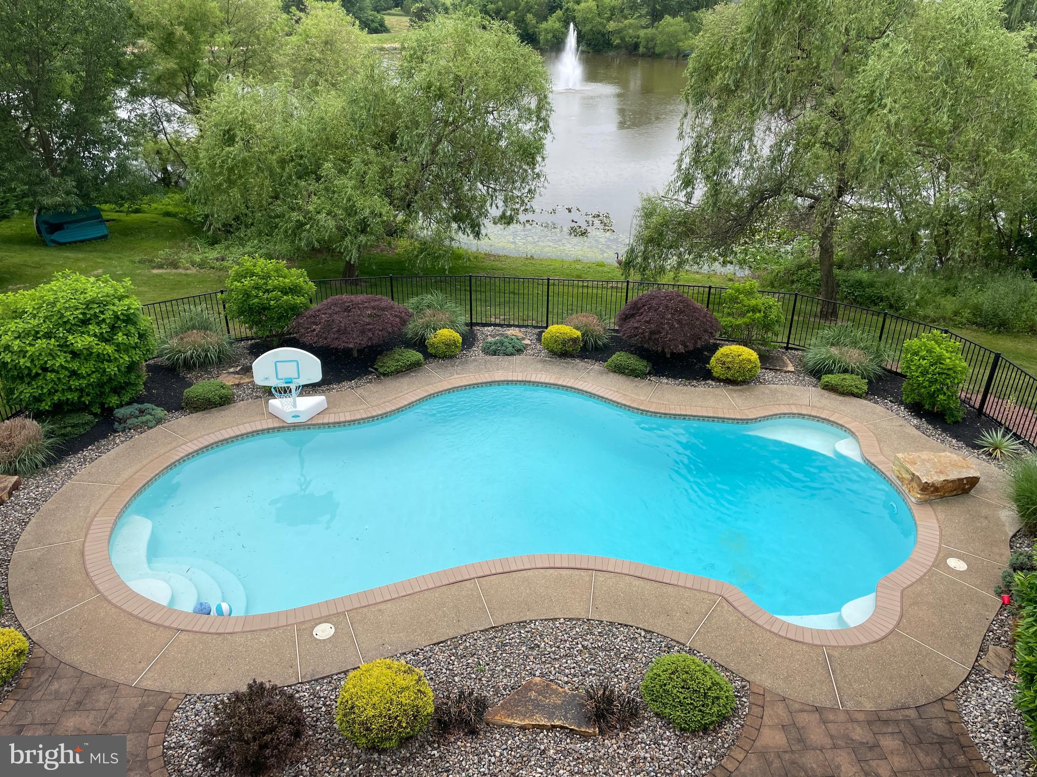 916 Nottingham Road Pottstown, PA 19465 - Photo 32 of 48 a view of a swimming pool with lawn chairs under an umbrella