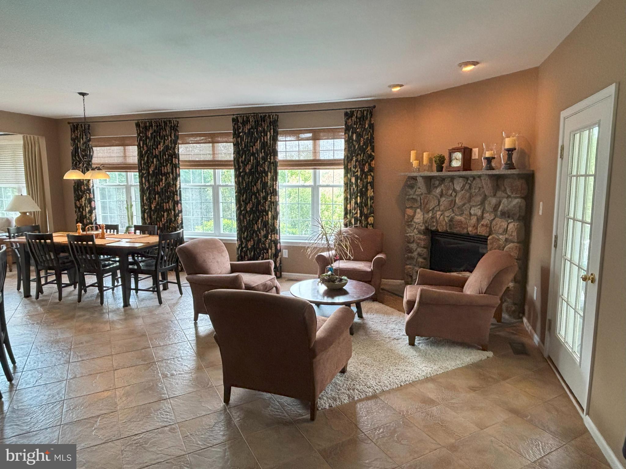 916 Nottingham Road Pottstown, PA 19465 - Photo 5 of 48 a living room with furniture a fireplace and large windows