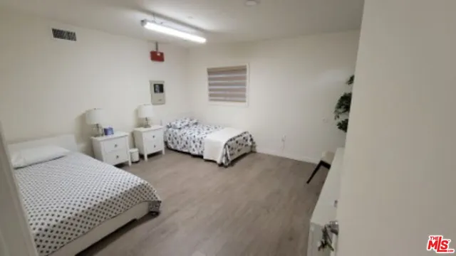 a bedroom with two beds and painted walls