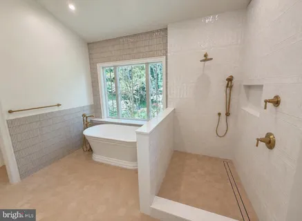 a bathroom with a granite countertop sink a toilet and shower