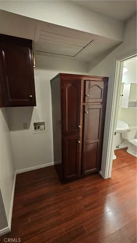 a view of a utility room with closet and wooden floor