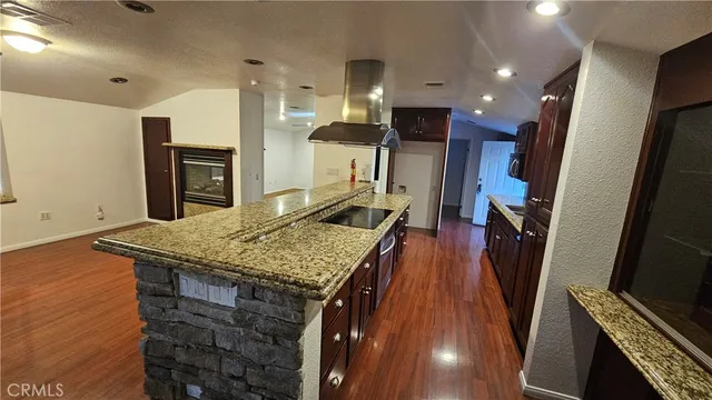 a kitchen with stainless steel appliances granite countertop a sink refrigerator and cabinets