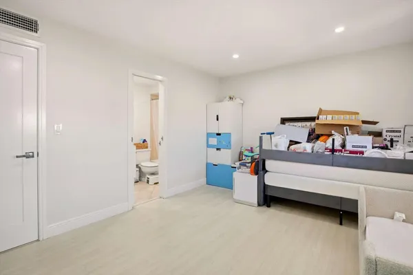 a bedroom with furniture and a chandelier