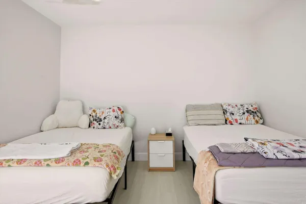 a bedroom with a bed and two lamp