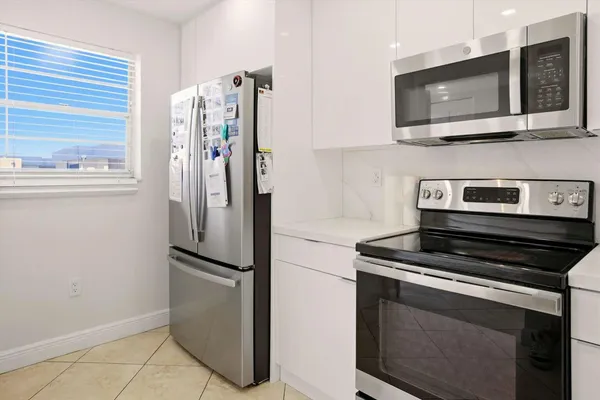 a kitchen with stainless steel appliances a refrigerator stove and microwave
