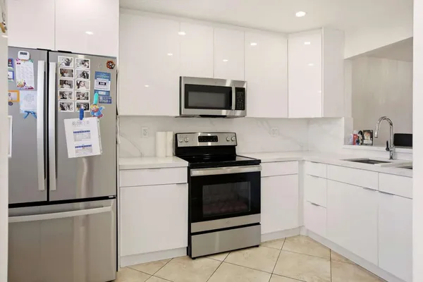a kitchen with stainless steel appliances a refrigerator stove and microwave
