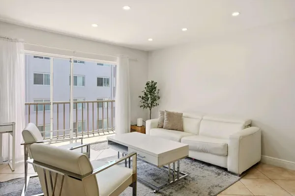 a living room with furniture a window and a table