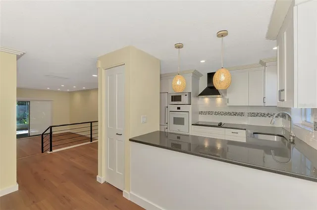 a view of a kitchen with wooden floor and stairs