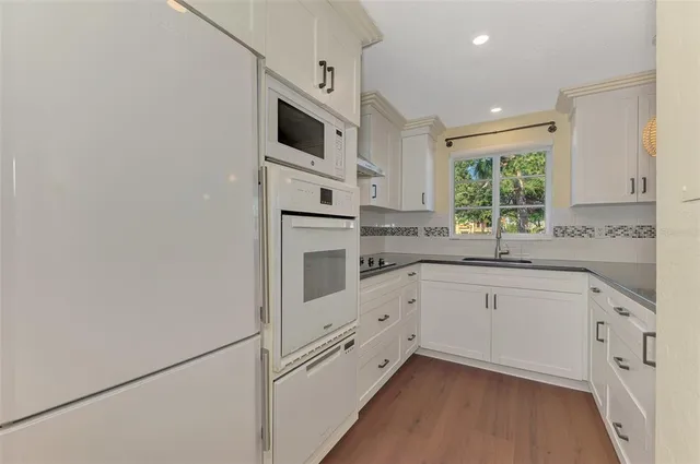 a view of a livingroom with wooden floor and window