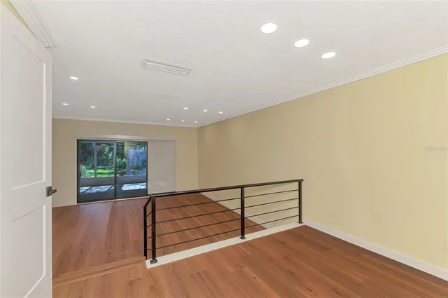 a view of a hallway with wooden floor and entryway
