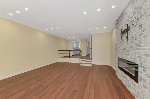 a view of an empty room and wooden floor
