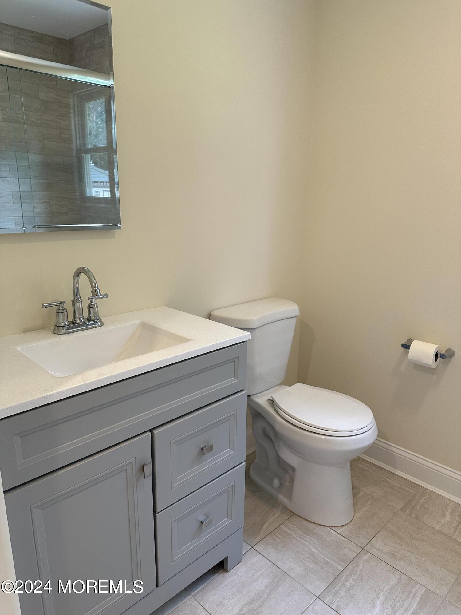 21 Middlesex Road Matawan, NJ 07747 - Photo 11 of 19 a bathroom with a toilet a sink and mirror