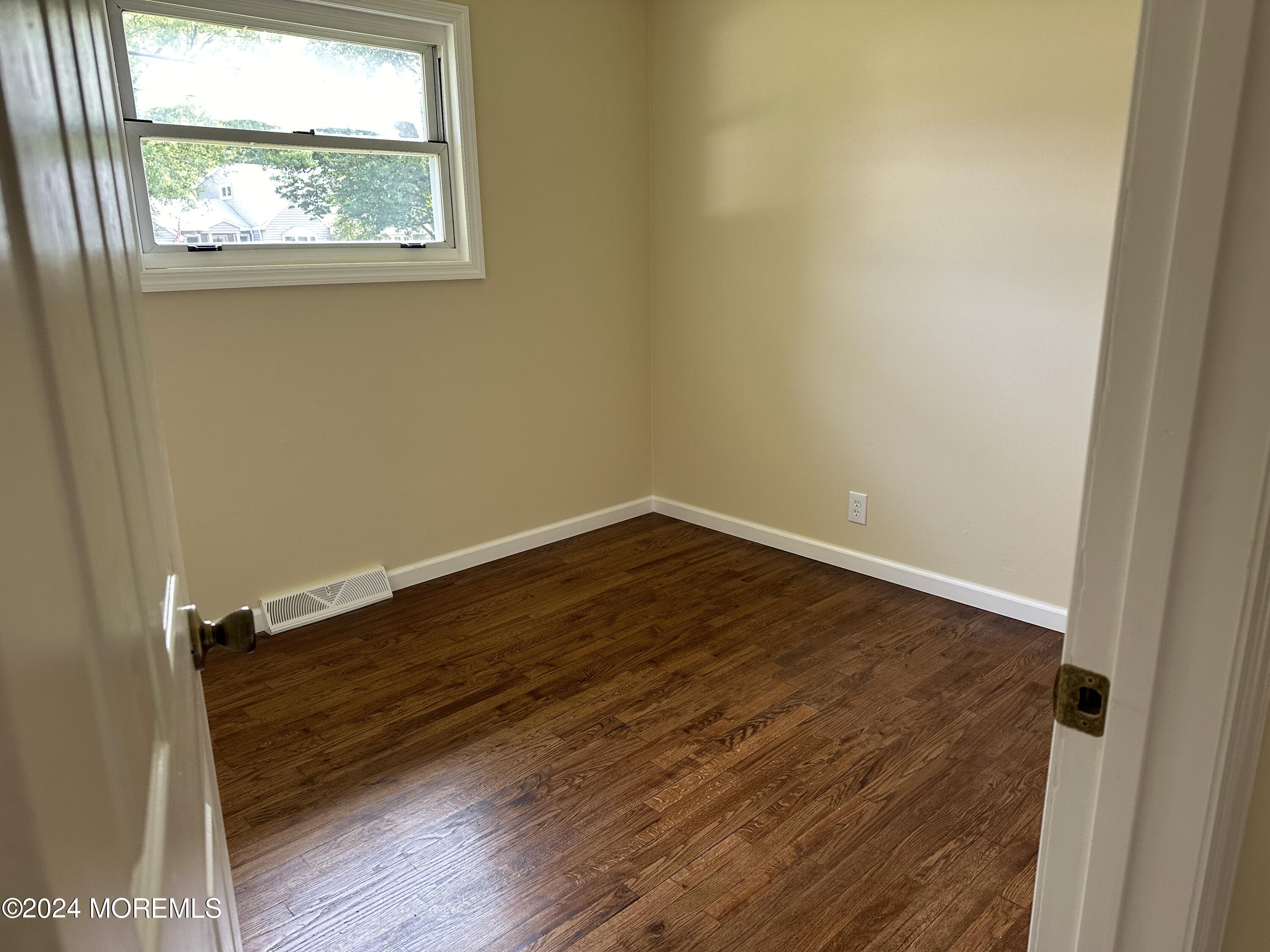 21 Middlesex Road Matawan, NJ 07747 - Photo 13 of 19 an empty room with wooden floor and windows