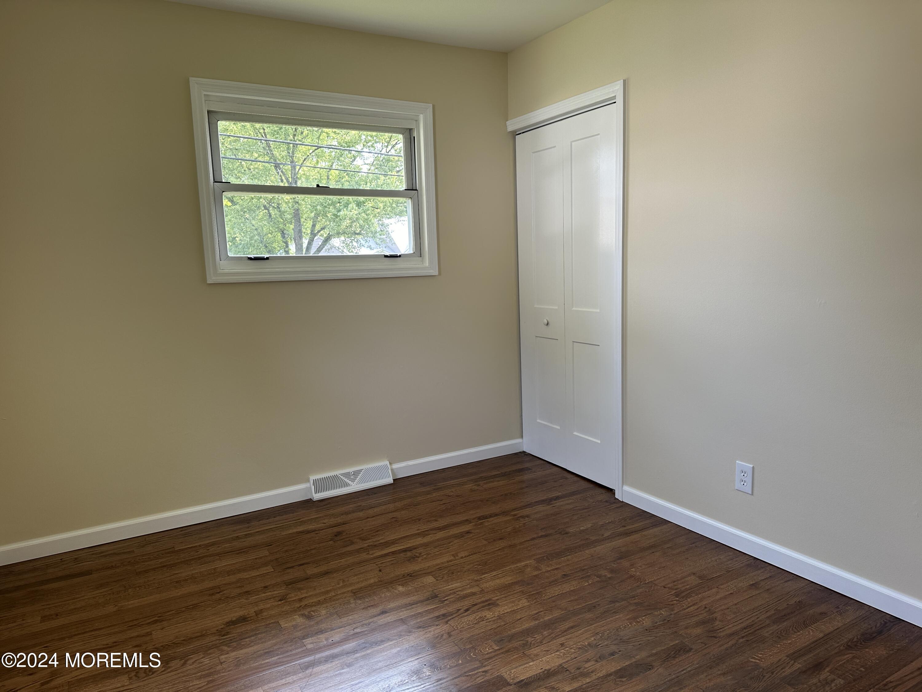 21 Middlesex Road Matawan, NJ 07747 - Photo 17 of 19 a view of an empty room with wooden floor and a window