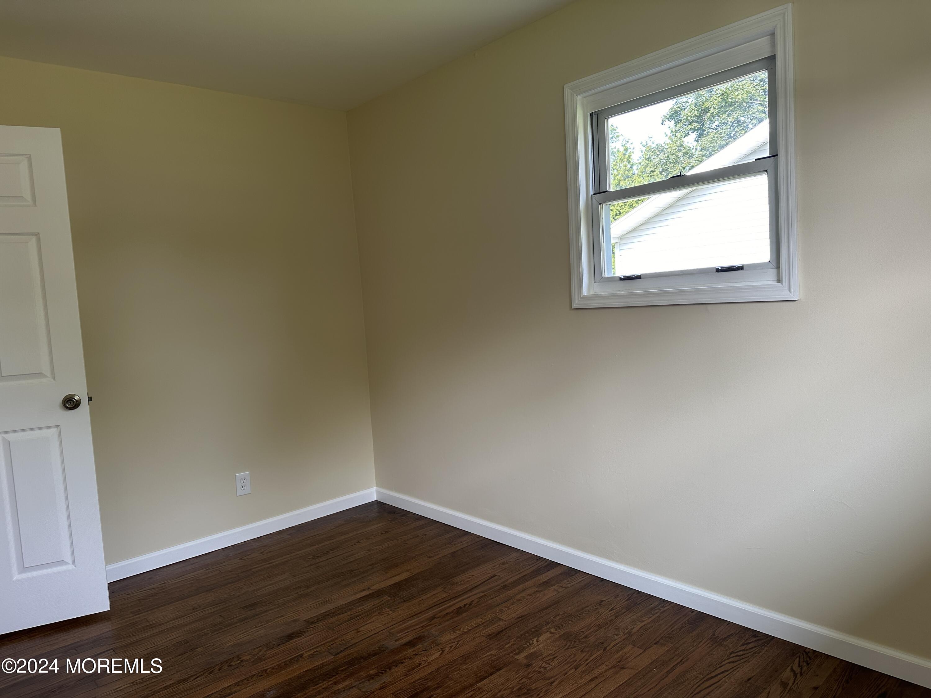 21 Middlesex Road Matawan, NJ 07747 - Photo 18 of 19 an empty room with wooden floor and windows