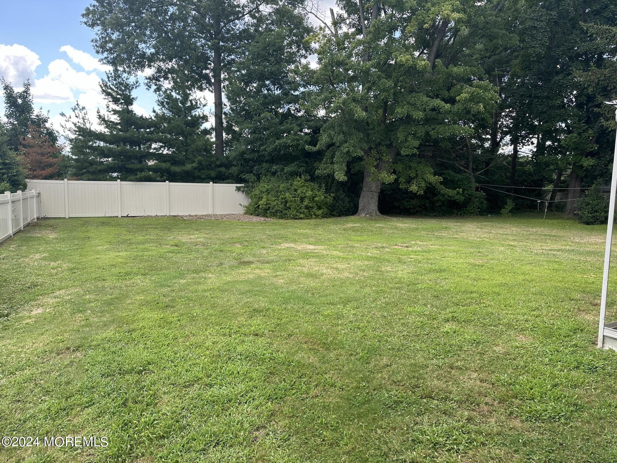 21 Middlesex Road Matawan, NJ 07747 - Photo 4 of 19 a view of a yard with a trees