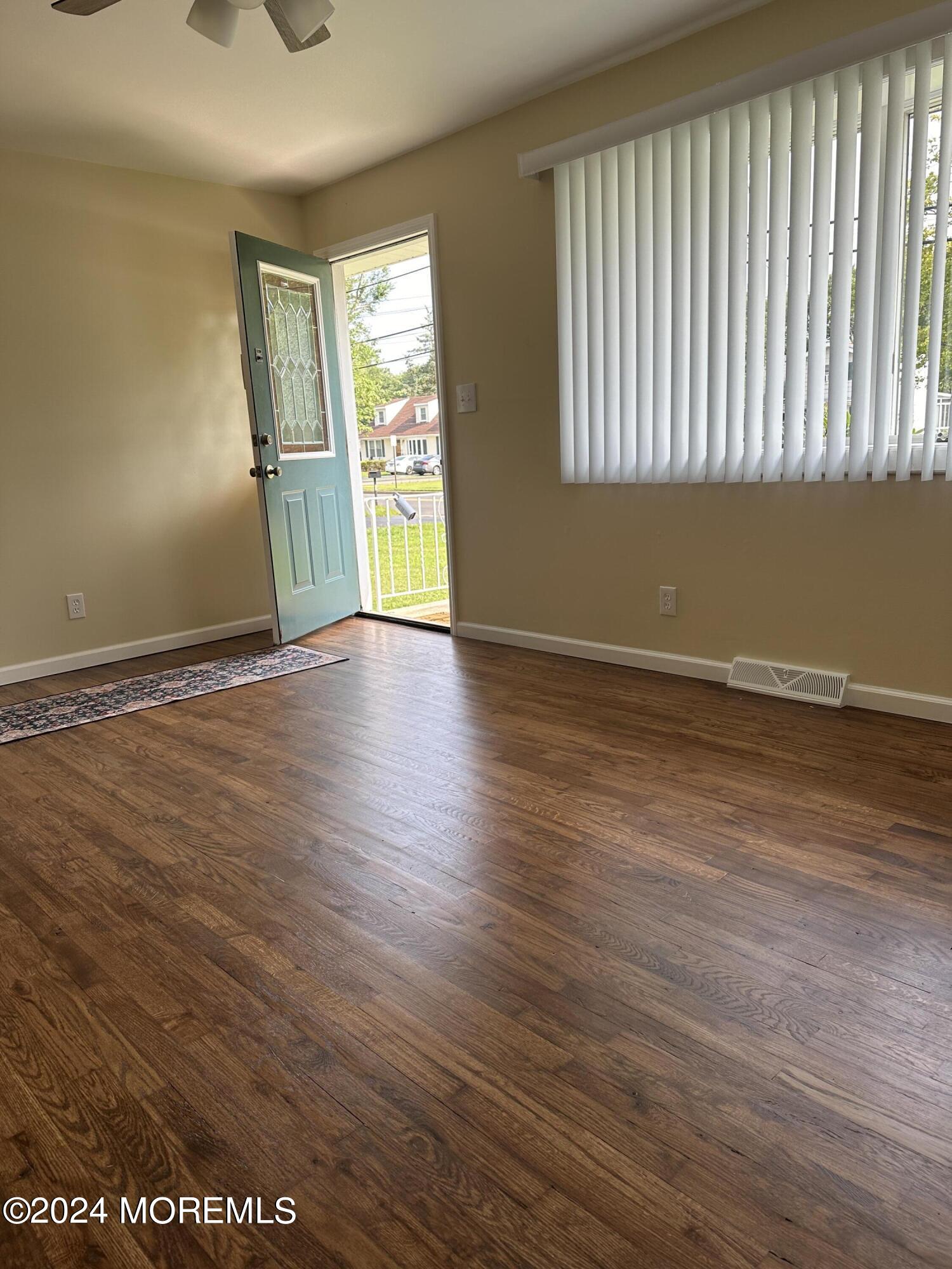 21 Middlesex Road Matawan, NJ 07747 - Photo 5 of 19 an empty room with wooden floor and windows