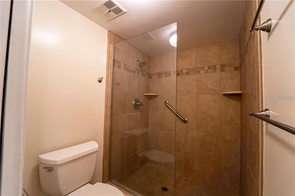a bathroom with a shower and toilet