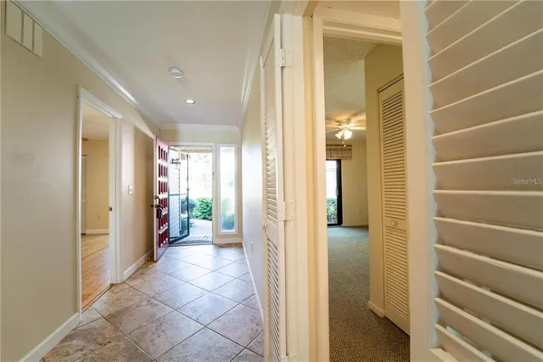 a view of a hallway with wooden shelves