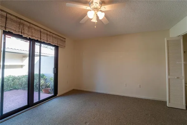 an empty room with windows and outdoor view