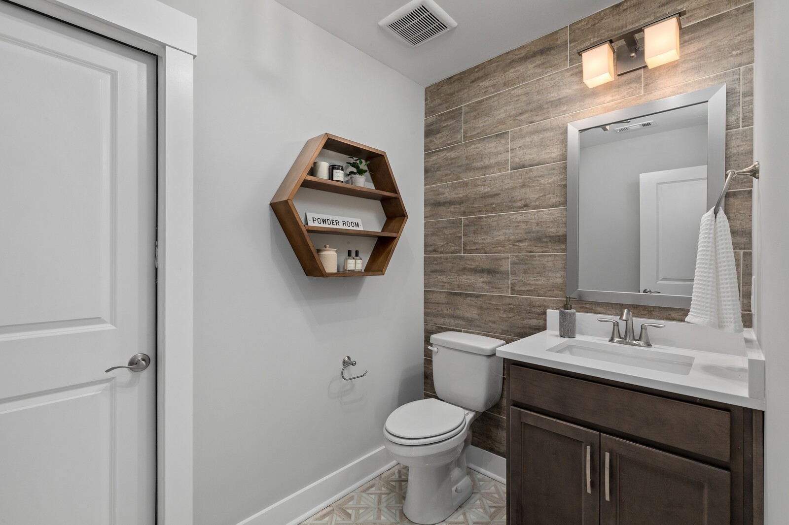 7272 Ruzek Court Fairview, TN 37062 - Photo 48 of 59 a bathroom with a toilet sink vanity and mirror