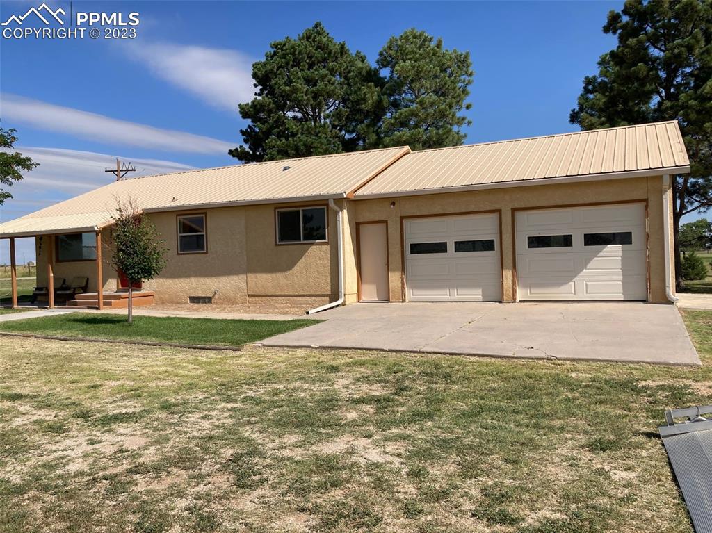 355 North Rush Road Rush, CO 80833 - Photo 21 of 41 a front view of a house with garden