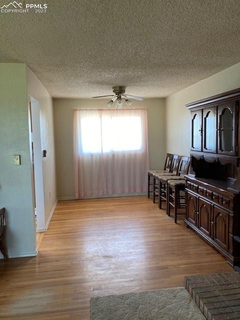355 North Rush Road Rush, CO 80833 - Photo 6 of 41 an empty room with wooden floor and windows