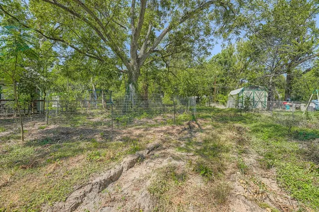 a backyard of a house with lots of green space and fountain