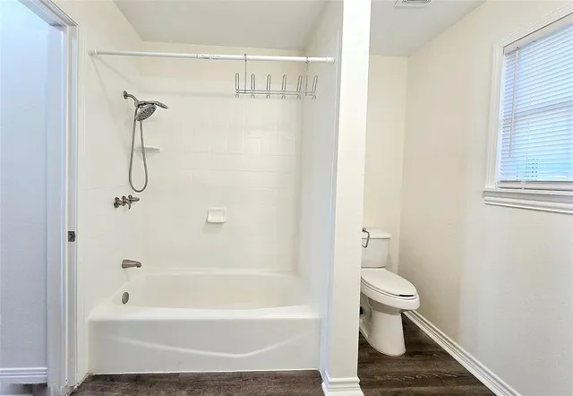 a bathroom with a toilet and a bathtub