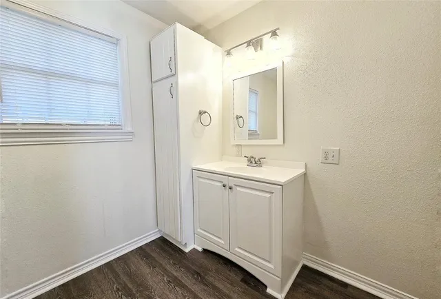 a bathroom with a sink mirror and vanity