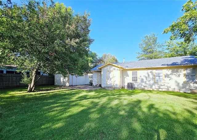a view of a house with a yard and sitting area